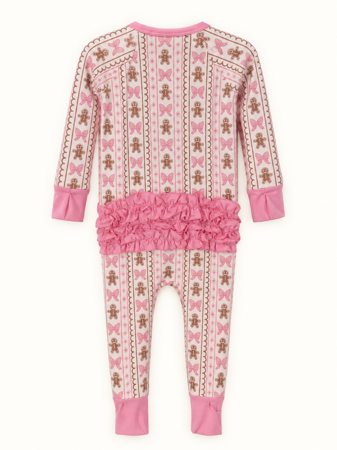 A baby long-sleeve footed pajama with a pink and white holiday pattern of gingerbread men, bows, and stripes, featuring a ruffled pink waistband and solid pink cuffs.