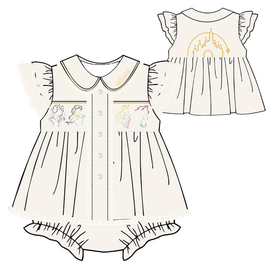 A line-art illustration of a baby dress shown from the front and back. The dress is cream/off-white with ruffled sleeves, a Peter Pan collar, front buttons, embroidered character motifs on the chest pockets, and a gold castle-and-rainbow design on the back.